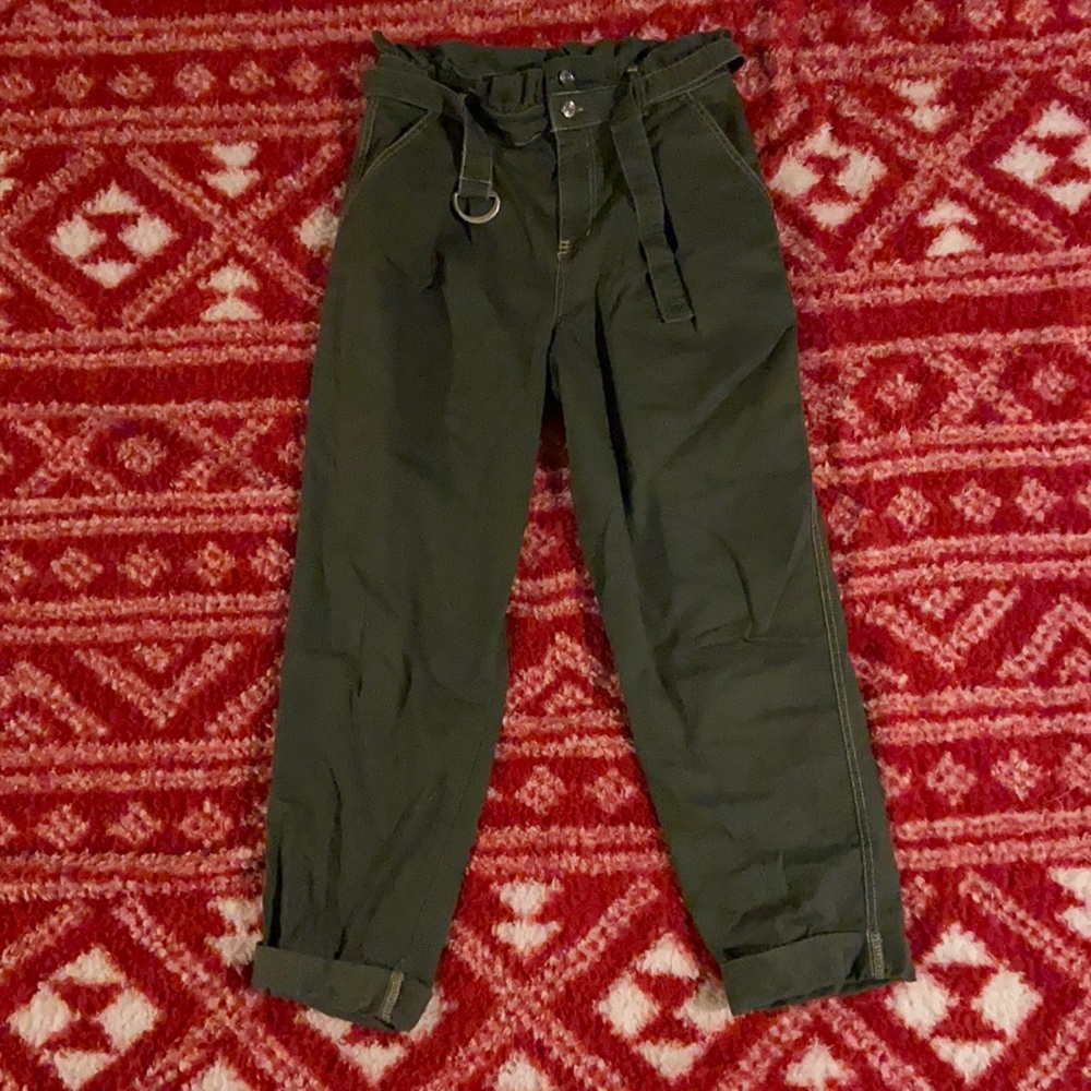 Green flared mom jeans with cuffed ankle.